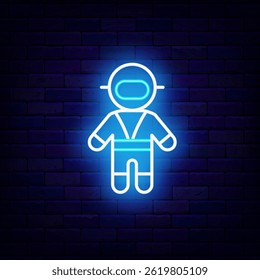 Astronaut in space suit. Cosmos passenger neon label. Sign on brick wall. Vector stock illustration