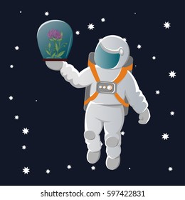 The astronaut in a white spacesuit with orange belts holds an airtight glass capsule with a flower in the outstretched hand against the background of the cosmos. International Cosmonaut Day.