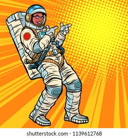 Astronaut young man points. African American people. Pop art retro vector illustration kitsch vintage drawing