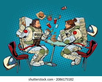 Astronauts man and woman couple date at fast food restaurant