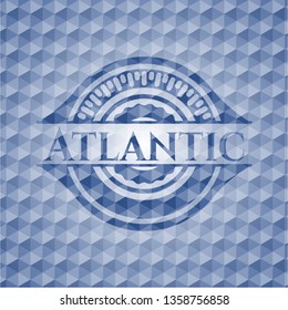 Atlantic blue badge with geometric background.