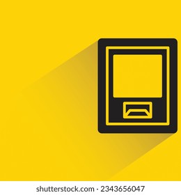 atm with shadow on yellow background
