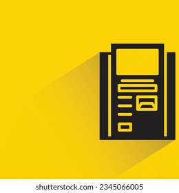 atm with shadow on yellow background