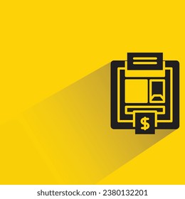 atm with shadow on yellow background