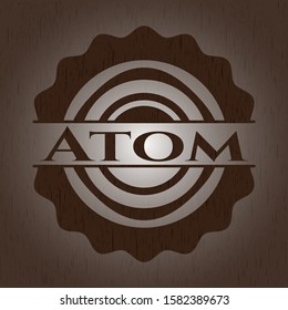 Atom badge with wooden background
