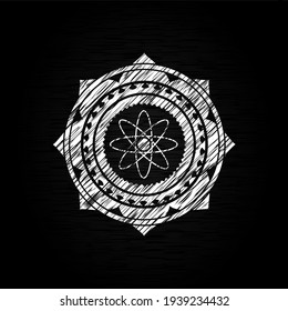 atom icon drawn on a chalkboard. 