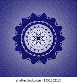atom icon inside badge with jean texture