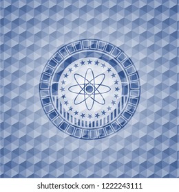 atom icon inside blue emblem with geometric pattern.
