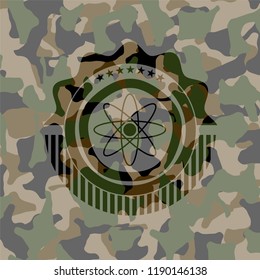 atom icon inside camouflaged emblem