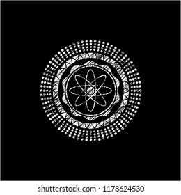 atom icon inside chalkboard emblem written on a blackboard