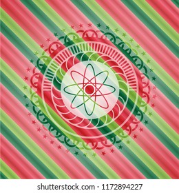 atom icon inside christmas colors style badge.