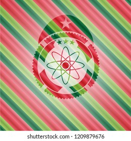 atom icon inside christmas colors emblem.