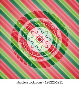 atom icon inside christmas colors emblem.
