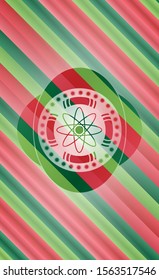 atom icon inside christmas colors emblem.