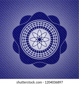 atom icon inside emblem with denim high quality background