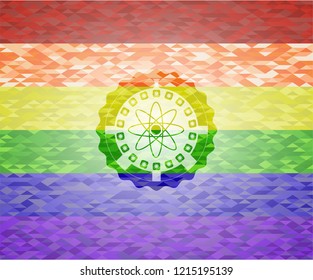 atom icon inside emblem on mosaic background with the colors of the LGBT flag