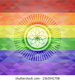 atom icon inside emblem on mosaic background with the colors of the LGBT flag
