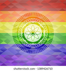 atom icon inside emblem on mosaic background with the colors of the LGBT flag