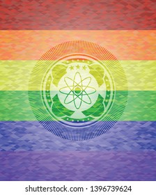 atom icon inside emblem on mosaic background with the colors of the LGBT flag