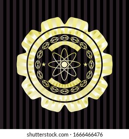 atom icon inside gold badge or emblem