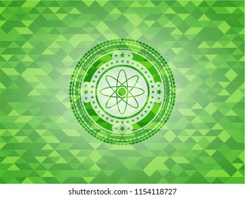atom icon inside green emblem. Mosaic background