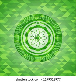 atom icon inside green emblem with mosaic ecological style background