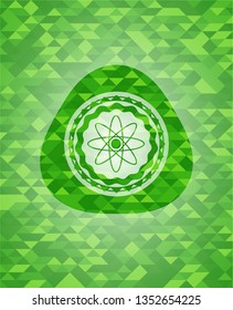 atom icon inside green emblem with mosaic ecological style background