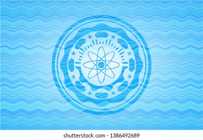 atom icon inside light blue water wave emblem background.