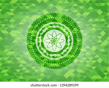 atom icon inside realistic green mosaic emblem
