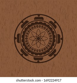 atom icon inside realistic wooden emblem