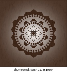 atom icon inside retro wood emblem