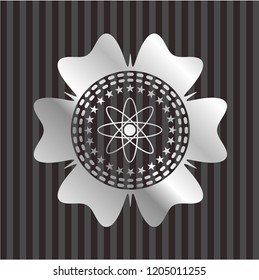 atom icon inside silvery badge or emblem
