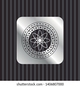 atom icon inside silvery shiny emblem