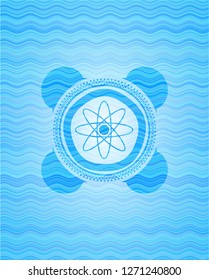 atom icon inside sky blue water emblem.