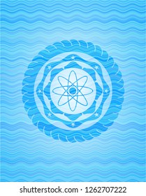 atom icon inside water concept badge.