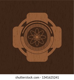 atom icon inside wood emblem. Vintage.