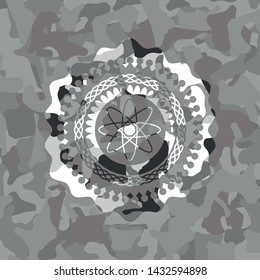 atom icon on grey camouflage texture