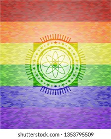 atom icon on mosaic background with the colors of the LGBT flag
