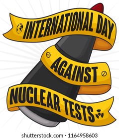 Atomic warhead with yellow ribbon wrapped around it with reminder for International Day Against Nuclear Tests.