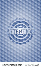 Attention blue badge with geometric pattern background.