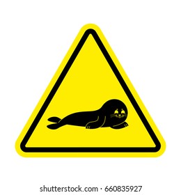 Attention Fur Seal. Caution small sea calf. Yellow triangle road sign