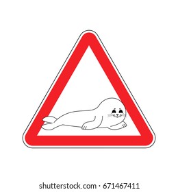 Attention Fur Seal. Caution small sea calf. Red triangle road sign