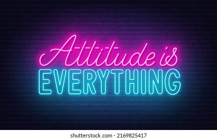 Attitude is everything neon quote on a brick wall.