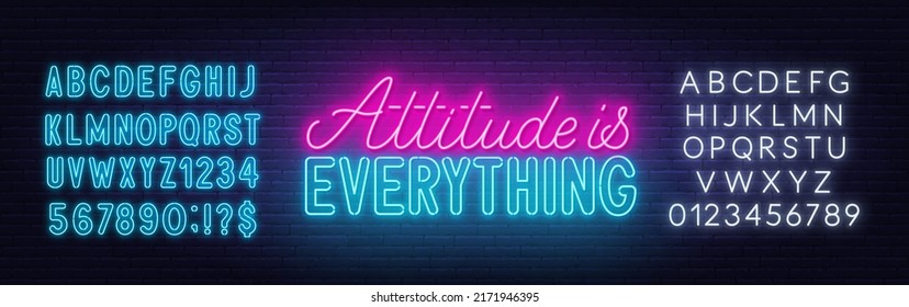 Attitude is everything neon quote on a brick wall.