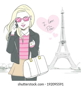 Attractive blonde woman talking with smartphone at Paris with pink heart saying I love Paris and Eiffel Tower background