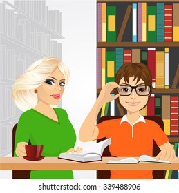 attractive blonde women drinking coffe and nerdy guy with glasses sitting with open books styding in the college library