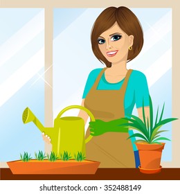 attractive lovely housewife on the balcony holding watering can