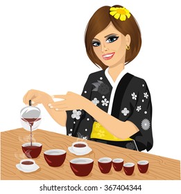 attractive woman in black kimono pouring tea