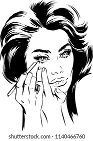 Attractive woman doing eye makeup