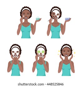 Attractive young black woman care her face and skin, using cream and applying natural mask. Facial treatment procedures.